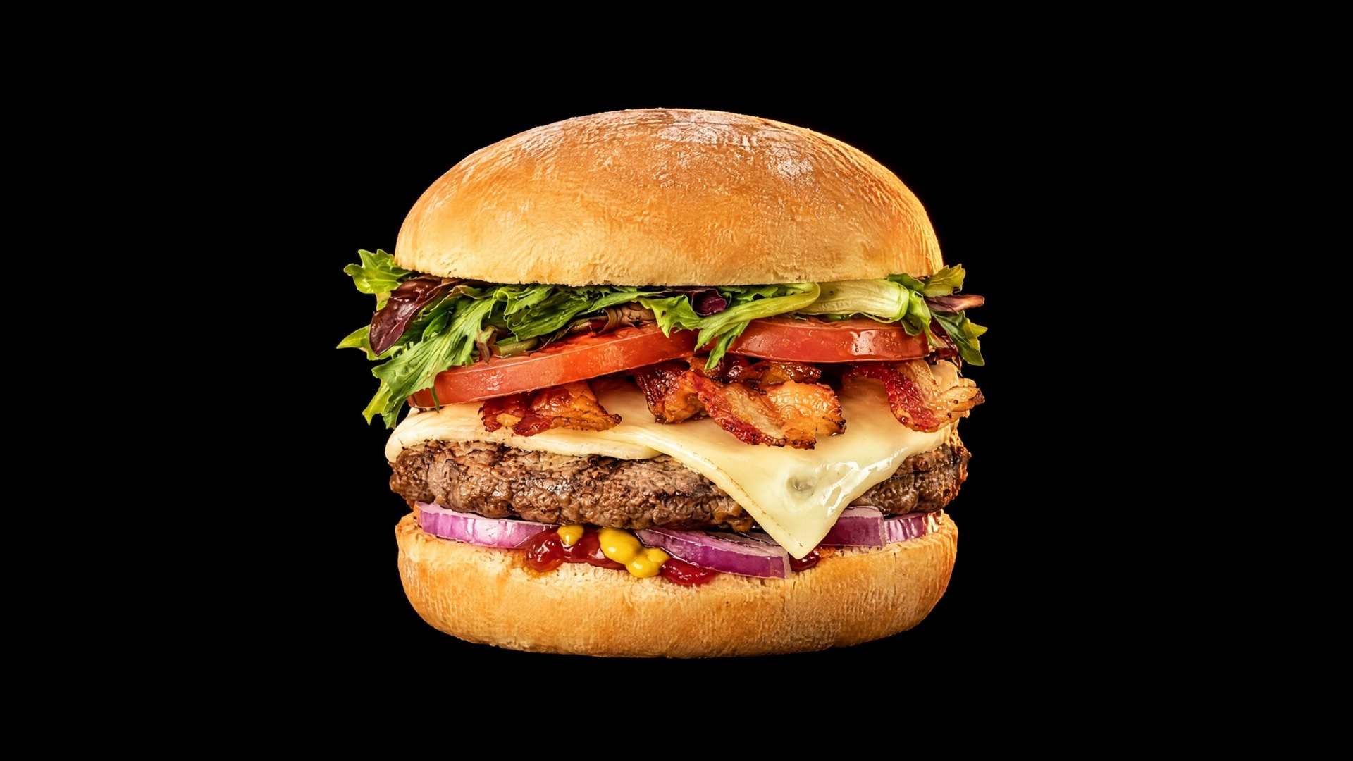 Le burger « Le Stanley » : pain doré, mesclun, tomates, bacon croustillant, fromage blanc fondu sur la galette de bœuf, oignon rouge, ketchup et moutarde